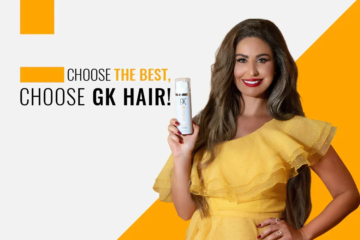 Woman with long wavy hair in a yellow dress holding a GK Hair Leave-In Conditioner Cream bottle