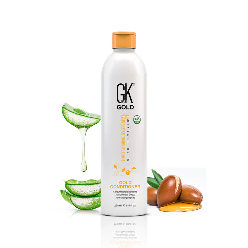 GK Hair Gold Conditioner Pro 250 ml bottle beside aloe vera slices and argan nuts on a white background