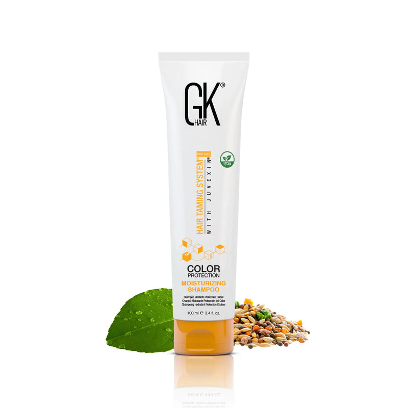 GK Hair Color Protection Moisturizing Shampoo 100 ml tube with a green leaf and mixed seeds on a white background