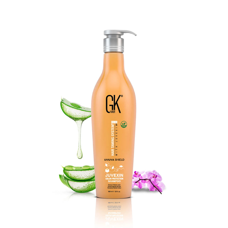 GK Hair UV/UVA Shield Color Protection Shampoo 650 ml orange pump bottle beside sliced aloe vera and a pink orchid
