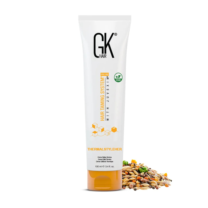 GK Hair ThermalStyleHer Cream Pro 100 ml tube on white beside a pile of mixed seeds and grains